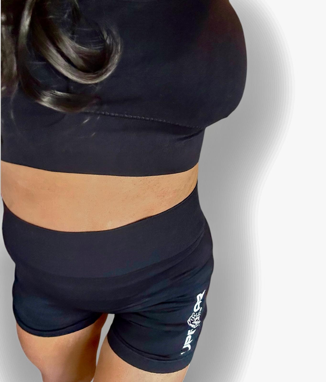 Black ribbed biker shorts for women, high waist for core support, compression fit, contrasting white logo, squat proof and camel toe proof, seamless, durable material