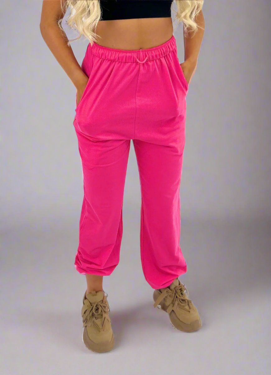 pink track pants for women with drop crotch, drawstring waist, elastic cuffed ankles and oversized look